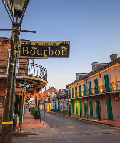 NEW ORLEANS, LOUISIANA - AUGUST 25: Bourbon Street sign with pubs and bars and neon lights  in the French Quarter, New Orleans on August 25, 2015  