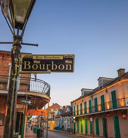 NEW ORLEANS, LOUISIANA - AUGUST 25: Bourbon Street sign with pubs and bars and neon lights  in the French Quarter, New Orleans on August 25, 2015  