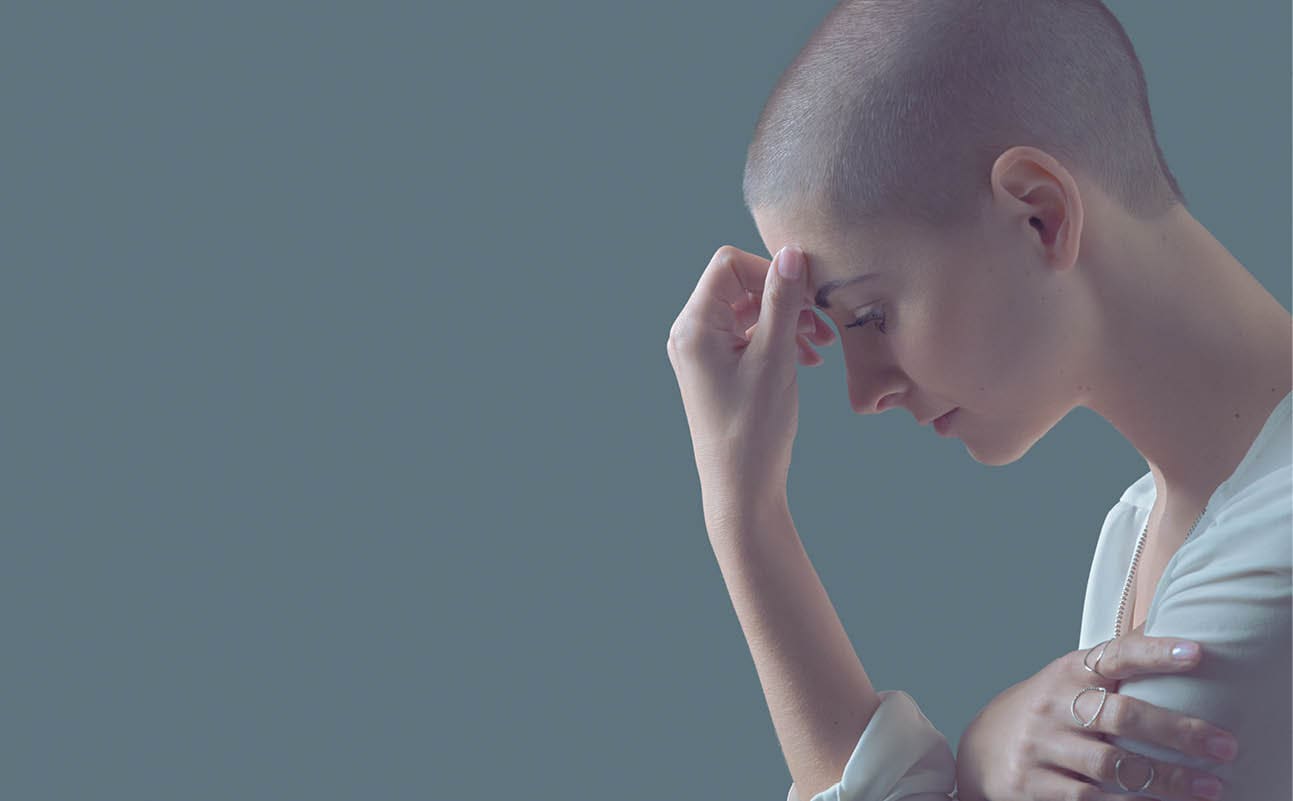 Sad, frightened and depressed female cancer patient portrait with copy space  Breast cancer patient, head in hands, portrait 